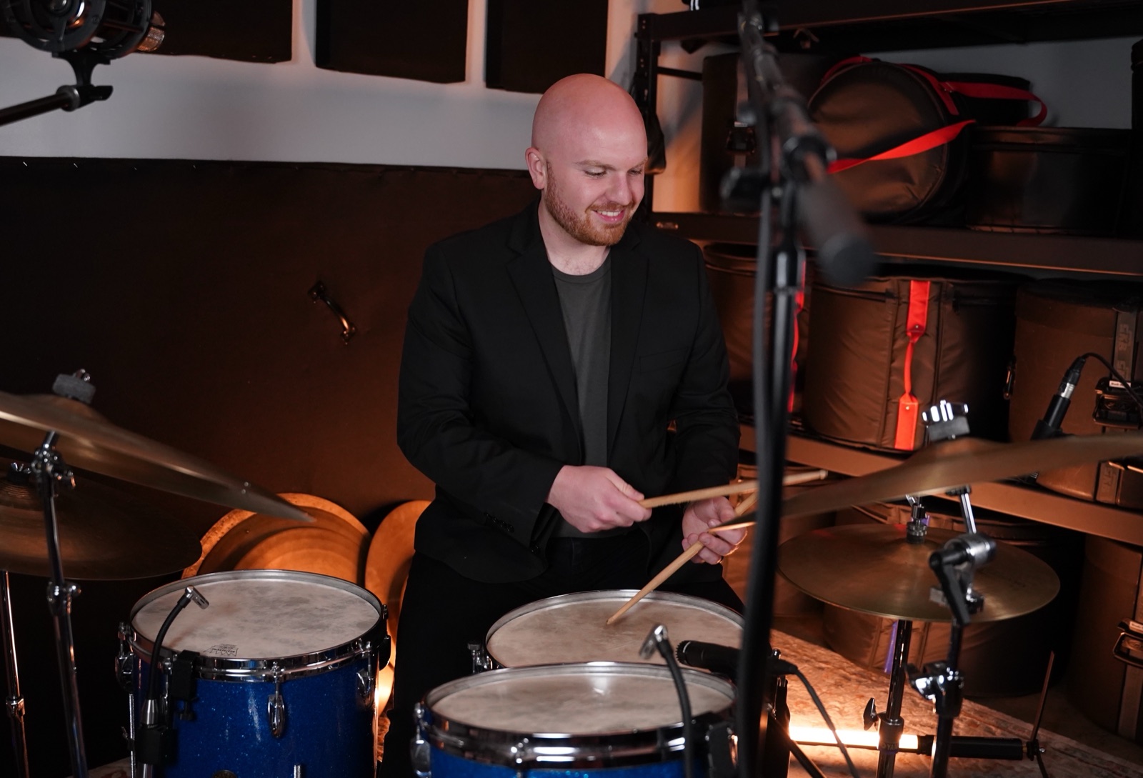 Ryan Shaw smiling at the drums